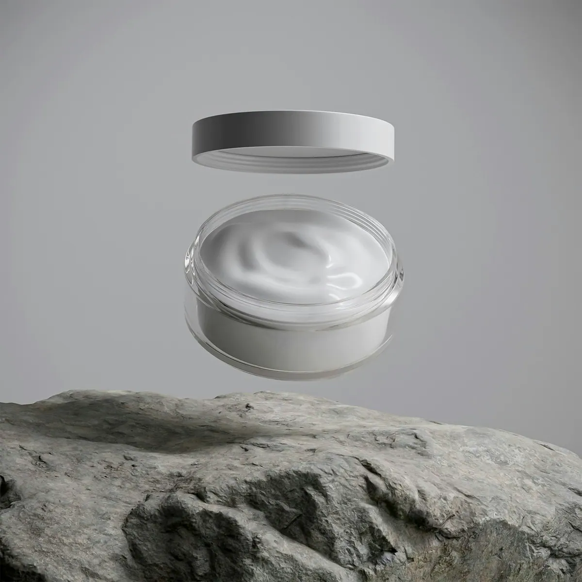 Open jar of white cream above a stone